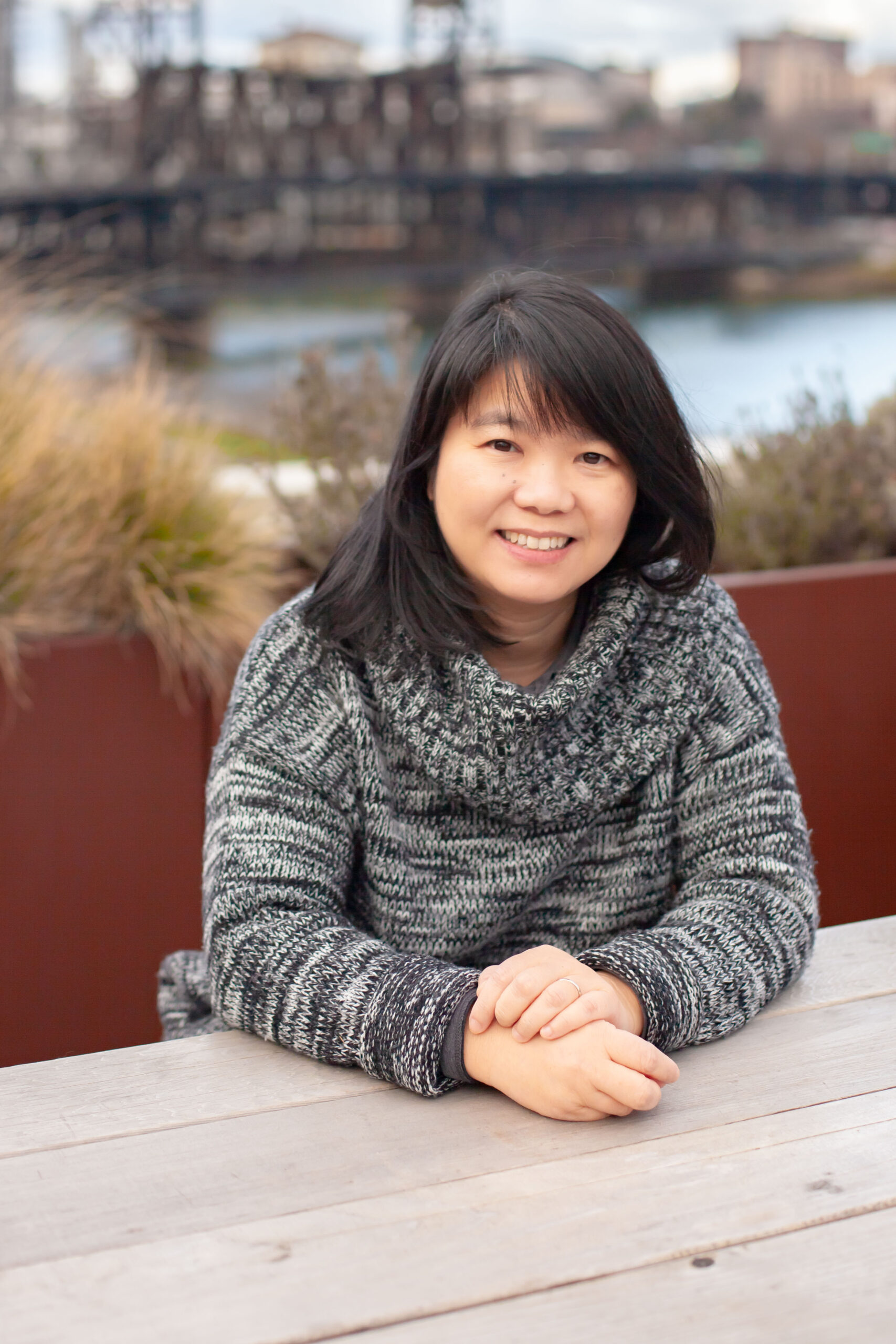 Architect and artist May Au poses atop the Ankrom Moisan Portland office.