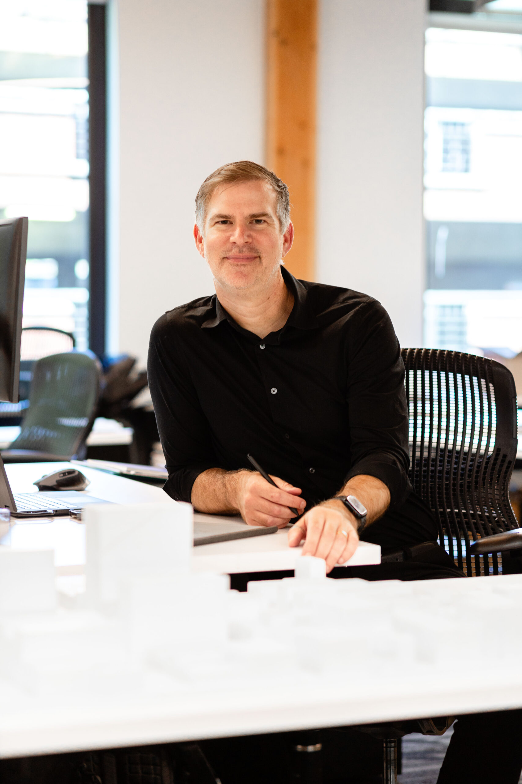 Michael Great at his desk in the Portland Office