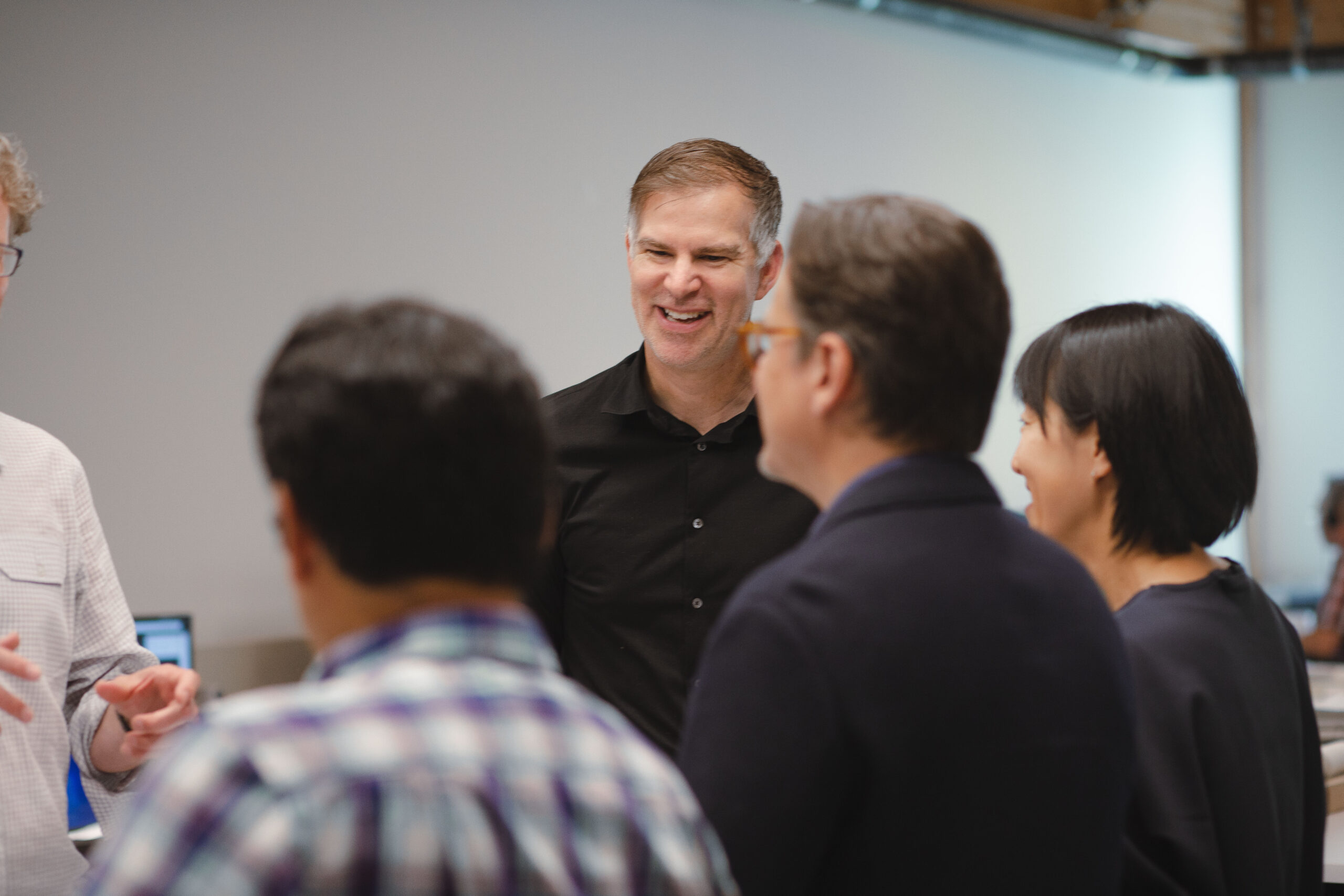 Michael Great chats with colleagues in the Ankrom Moisan Portland office