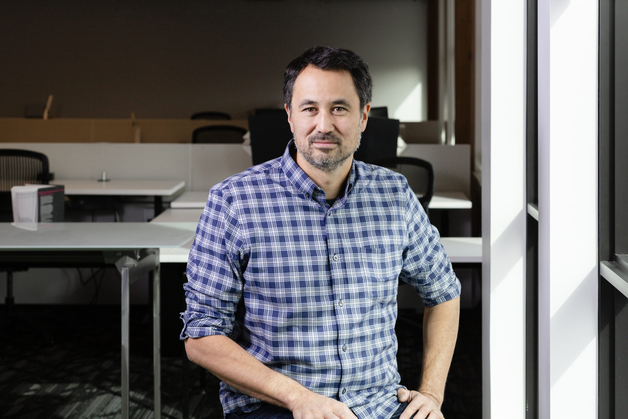 Mike Stapleton sits at his desk in the Portland office.